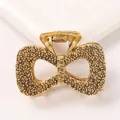 Detail of vintage gold bow hair claw clip with unique hammered metal texture and spring - Bowknot - Antique Gold