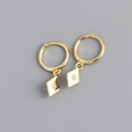 Detail of gold rhombic hoop earrings featuring a starburst engraving and zircon stone - 925 Silver / Gold Color (Pair)