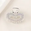 Macro view of silver heart hair claw clip with detailed embossed rose flower texture - Heart Style - Silver