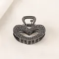 Detailed view of gun black hollow heart hair claw clip with embossed rose pattern - Heart - Gun Black
