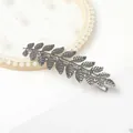 Close-up of silver metal alloy duckbill clip with intricate branch and leaf textures - Silver Leaf Duckbill Clip