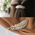 Elegant gold feather hair clip with white pearls and rhinestones shown on model and cloth - Pearl Feather Spring Clip