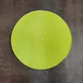 Handwoven round PP placemat in bright lime green color with a spiral braided texture - Fruit Green