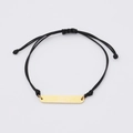 Macro detail of adjustable black braided bracelet with polished gold rectangle bar charm - Standard (MP633) / Gold
