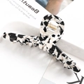 Close-up of a large black and white marble acetate hair claw clip with golden metal spring - S137-8 Black & White Ink