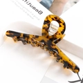 Close-up of tortoise shell pattern hair claw clip with glossy finish and metal spring - S137-6 Amber Leopard