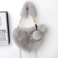 Detail of grey heart-shaped faux fur bag with golden chain and plush pompom charms - Light Gray