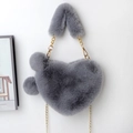 Detail of grey heart-shaped faux fur bag with golden chain strap and plush pom-poms - Medium Grey