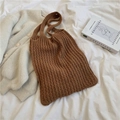 Brown knit tote bag with thick woven texture on white linen with artistic book - Brown