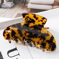 Detail of large tortoise shell hair claw clip with glossy leopard pattern and multi-tooth design - S139-6 Amber Spotted
