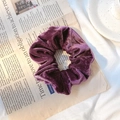 Elegant purple velvet scrunchie accessory for women on a stylish aesthetic background - Deep purple