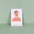Detail of small dark stud earrings displayed on a white illustrative jewelry card - 6x9cm