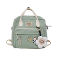 Detail of light green canvas backpack with plush flower pendant and cute decorative pins - Pink