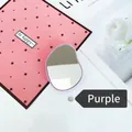 Close-up of ergonomic purple handheld beauty mirror on a minimalist white backdrop - Expanding Stand / Purple Oval Mirror