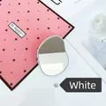 Close-up of a white pebble-shaped portable crystal hair remover with a mirror finish - Expanding Stand / White Oval Mirror