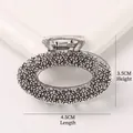 Detail view of a vintage silver alloy hair claw clip with grainy texture, size 4.5x3.5cm - Oval - Antique Silver