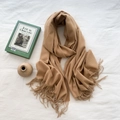 Camel cashmere feel scarf with soft fringe edges styled with vintage book and ceramic decor - Golden Camel