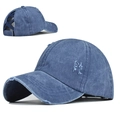 Detail view of washed blue ponytail baseball cap featuring cross elastic back and distressed edges - Criss Cross Ponytail / Navy Blue