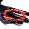 Macro shot of natural red agate beads and silver tube bracelet on a black hand model - Striped Red Agate