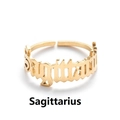 Macro shot of gold Sagittarius constellation lettering on a stainless steel open ring - Sagittarius