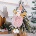 Pink plush Christmas angel tree ornament with gold wings hanging on a frosted pine branch - Snowflake Wand Style / Pink