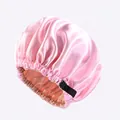 Detail of pink satin sleep bonnet showing the adjustable buckle and double-layer fabric - Pink