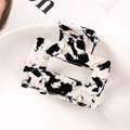 Macro view of a rectangular hollow hair claw with black and white marble pattern texture - 7145-9 Black & White Pattern