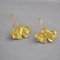 Detailed view of golden ginkgo leaf drop earrings with hammered matte texture details - Ginkgo
