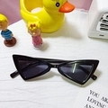 Vintage black triangle cat-eye sunglasses for kids on white knitted background - Black Frame Grey Lens