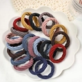 Elastic hair ties in various colors like pink and blue displayed on a white plate - Twist Pattern / 20 Pieces / Multicolor