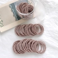 Elastic hair bands in dusty rose color arranged neatly with a clear storage jar - 100 Pieces Set / Pink