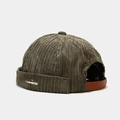 Close-up of olive corduroy brimless cap featuring a small white whale embroidery detail - Army Green