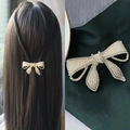 Golden bow hair clip with pearls and rhinestones shown on model and close-up - Hollow Elegant Pearl Spring Clip