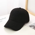 Close-up of black fleece texture on winter baseball cap with soft thermal lambskin fabric - Black