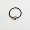 Close-up of leopard print cube charm on a high-elasticity black hair tie for women - Light Tortoiseshell