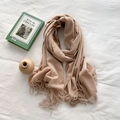Minimalist beige cashmere-style scarf with soft tassels in a stylish flat lay setup - Khaki