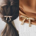 Elegant gold bowtie hair clip with sparkling rhinestones shown on hair and silk - Gold Luxury Bow Spring Clip