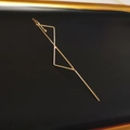 Minimalist gold geometric earring featuring a sleek triangular hook design on black - Cross Triangle Gold