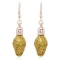 Detail view of light bulb shaped earrings with festive golden glitter and rose gold hooks - Dinosaur Small but Strong