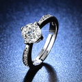 Macro detail of silver six-prong moissanite ring with side stones on dark blue background - Y099【1 Carat】