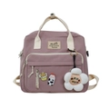 Detail of pink canvas backpack with cute pins and soft plush flower keychain accessory - Green