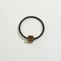 Detail of high-elastic black hair tie featuring a polished leopard print square bead - Dark Tortoiseshell