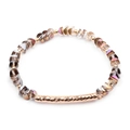 Detail of faceted grey crystal beads and a hammered gold-tone curved tube on the bracelet - Smoky Grey Aurora