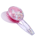 Close-up of unicorn air cushion hairbrush with moving colorful beads and pink bristles - Colorful Mane