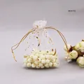 Close-up of white organza jewelry drawstring bag with gold-stamped stars and moon - 7*9cm / Platinum