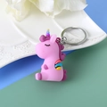Cute pink PVC unicorn keychain with silver ring on decorative white ceramic plate - Lilac Large