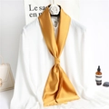 Elegant gold silk scarf tied on white shirt collar, professional studio shot display - Turmeric