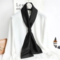 Detailed close-up of a long black satin scarf elegantly knotted on a white shirt - Black