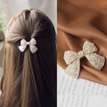 Elegant bow-shaped hair clip featuring white pearls on a gold-tone metal base - Premium Elegant Pearl Bow Spring Clip