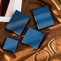 Dark blue jewelry gift boxes in four sizes with textured finish on brown silk background - Leoni Striped Royal Blue; 7*7*1.5cm